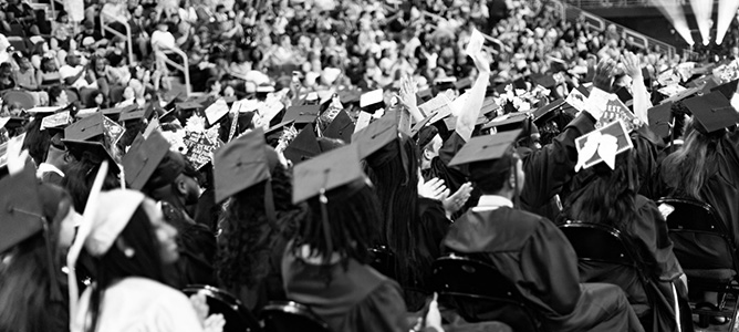 Black and image of graduates and crowd at Penn Foster’s 2024 Graduation ceremony.